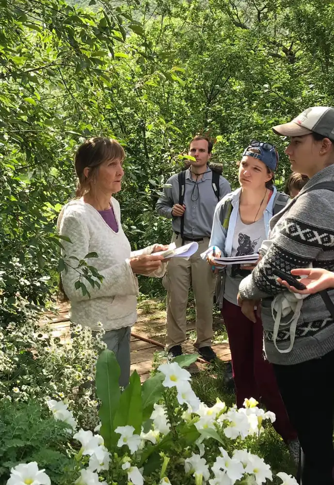 Feather Jones teaching students during an outdoor plant walk